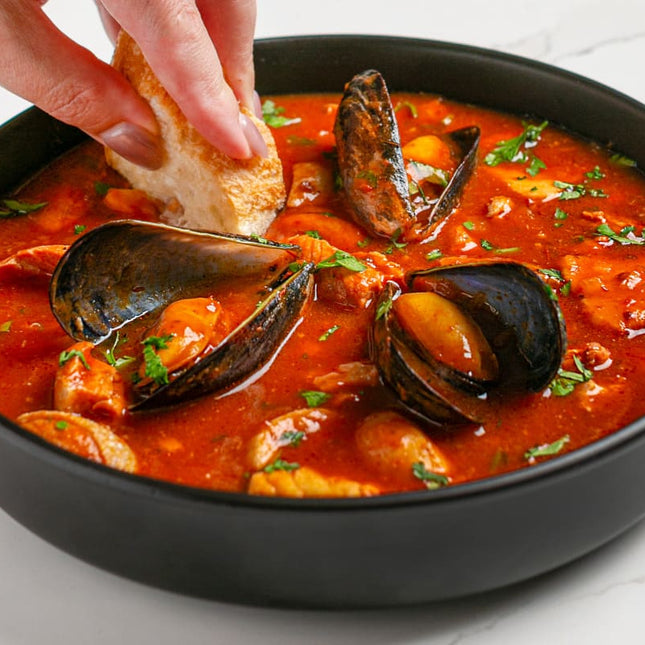 A Spanish seafood stew with a richly flavoured base of crushed almonds, garlic and smoked paprika, served with crusty bread.