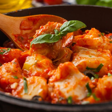 A classic coastal dish of cod gently simmered in a rich tomato, white wine and aromatic sauce.