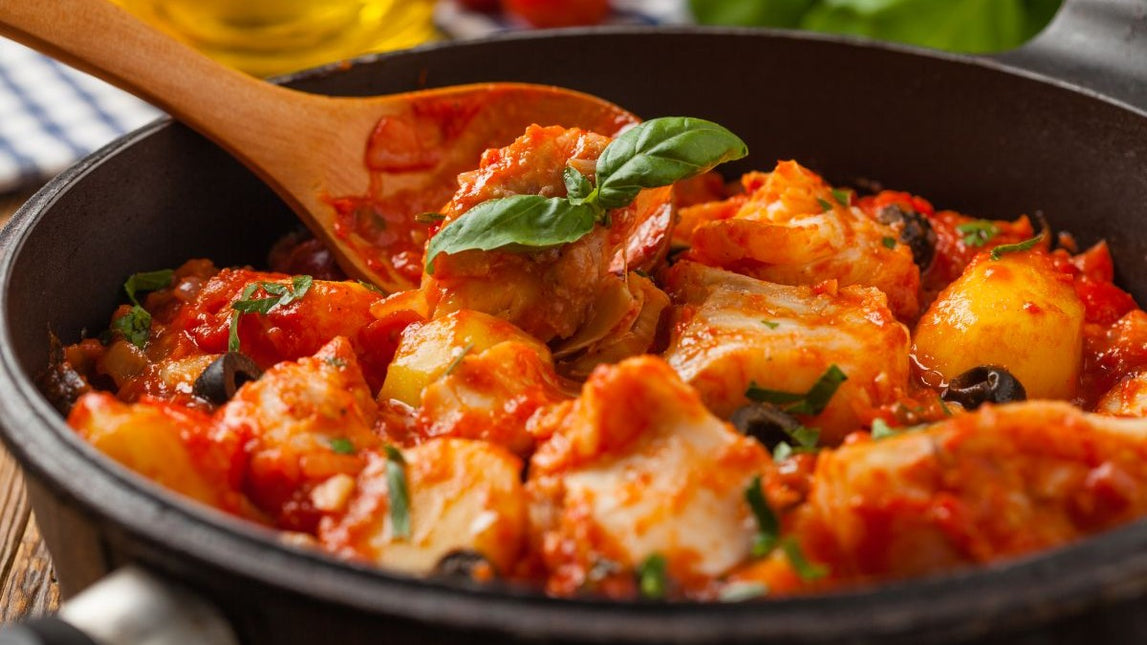 A classic coastal dish of cod gently simmered in a rich tomato, white wine and aromatic sauce.